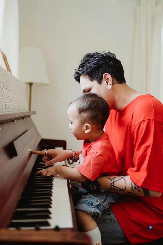 a man playing the piano with his son, pexels contest winner, jen atkin, bao pham, thumbnail, lgbtq