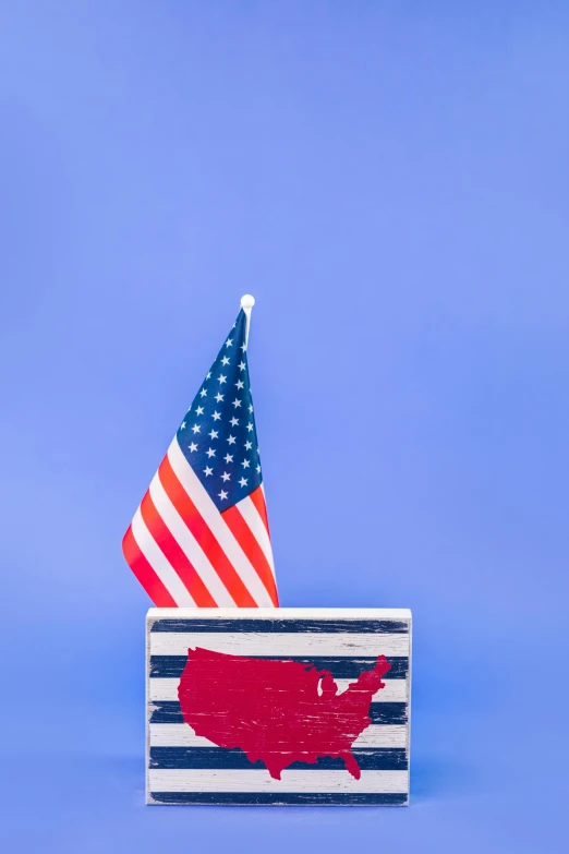 a wooden block with an american flag sticking out of it, by Alison Geissler, shutterstock contest winner, a brightly colored, rhode island, slide show, navy
