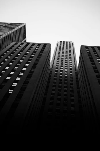 a black and white photo of tall buildings, by Andrew Domachowski, postminimalism, square lines, three, black on black, business