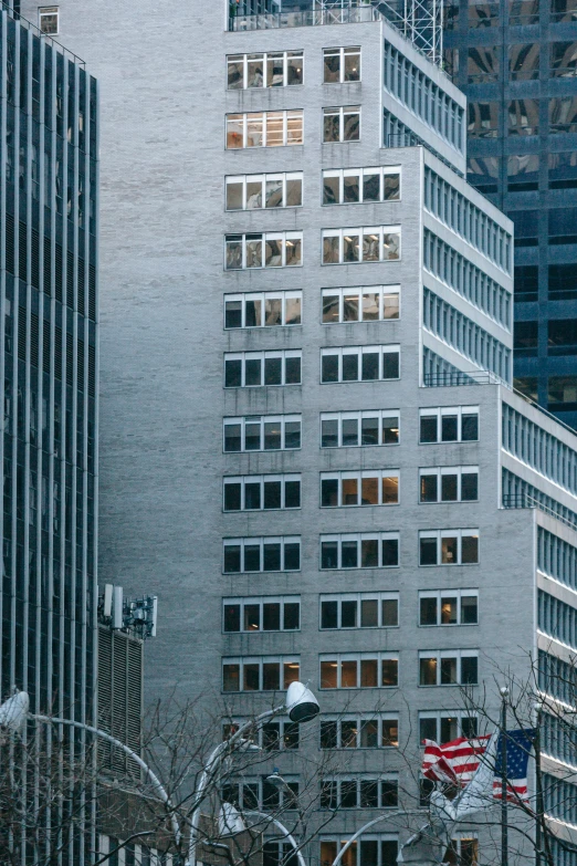 a group of people walking down a street next to tall buildings, a photo, by Sven Erixson, pexels contest winner, modernism, little windows, perched on a skyscraper, low detail, windows and walls :5