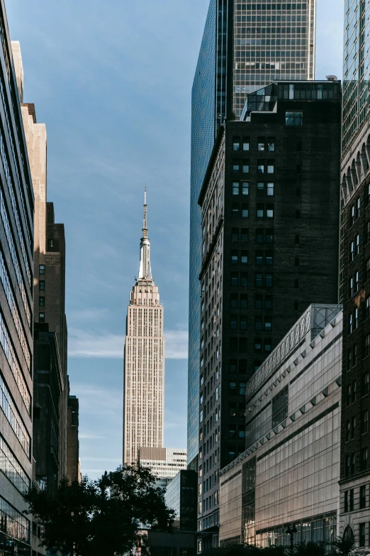 a city street filled with lots of tall buildings, unsplash contest winner, modernism, empire state building, slide show, brown, exterior