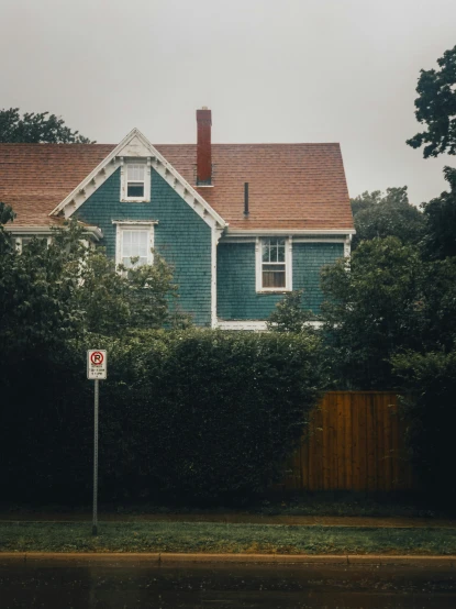 a house with a no parking sign in front of it, pexels contest winner, arts and crafts movement, william eggleston, hedge, overcast, new england architecture