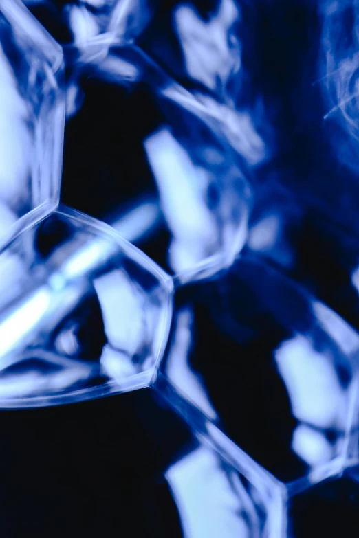 a bunch of ice cubes sitting on top of each other, a microscopic photo, pexels, crystal cubism, whirling blue smoke, dna strands, abstract design. parallax. blue, looking to the right