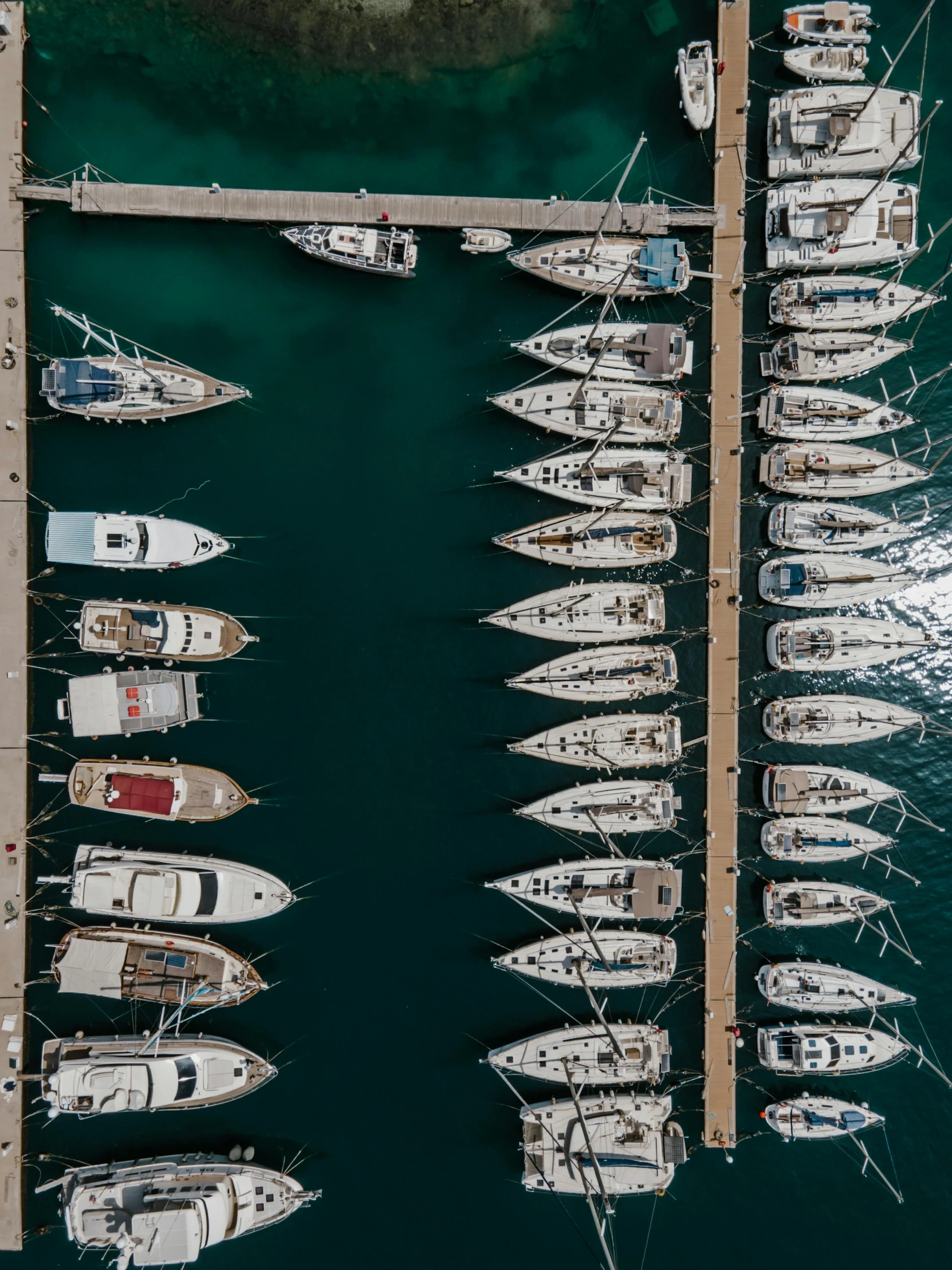 a number of boats in a body of water, by Sebastian Spreng, pexels contest winner, looking down on the view, docked at harbor, top down perspecrive, standing on the mast