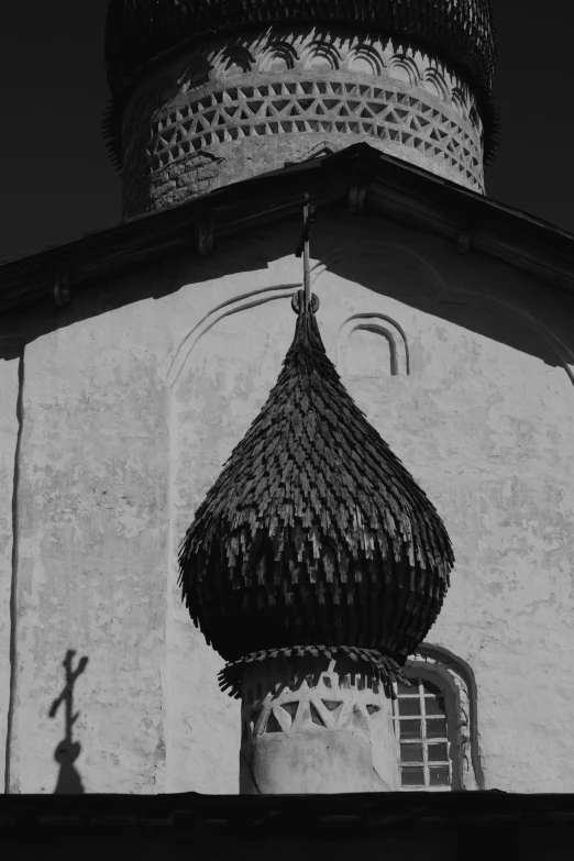 a black and white photo of a church, an album cover, inspired by Andrei Rublev, pexels contest winner, crown of very long feathers, an unknown ethnographic object, hasbulla magomedov, rounded roof