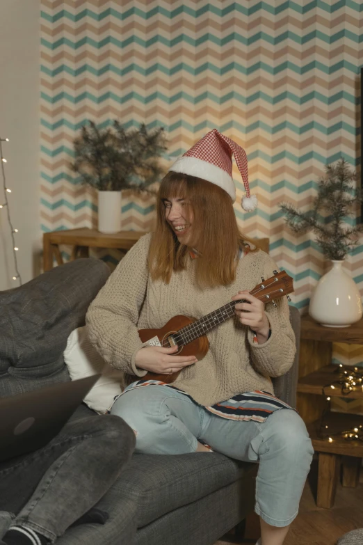 a woman sitting on a couch playing a guitar, reddit, happening, wearing festive clothing, youtube thumbnail, ukulele, avatar image