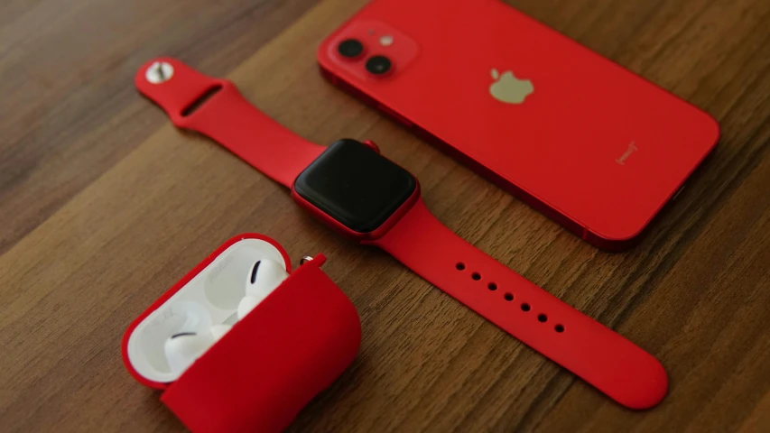 a red apple watch sitting on top of a wooden table, pexels, airpods, all red, square, iphone picture