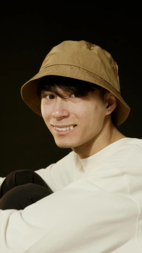 a man in a hat holding a baseball bat, inspired by Junpei Satoh, unsplash, mingei, headshot profile picture, bucket hat, around 1 9 years old, close - up studio photo
