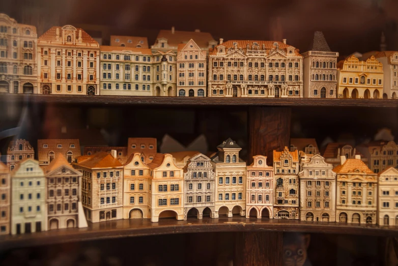 a display case filled with lots of miniature buildings, by Emma Andijewska, pexels contest winner, folk art, prague, brown, panorama, ivory and copper