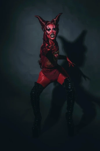 a woman wearing a devil mask and boots, transgressive art, face and skin is dark red, red giant, press shot, drag