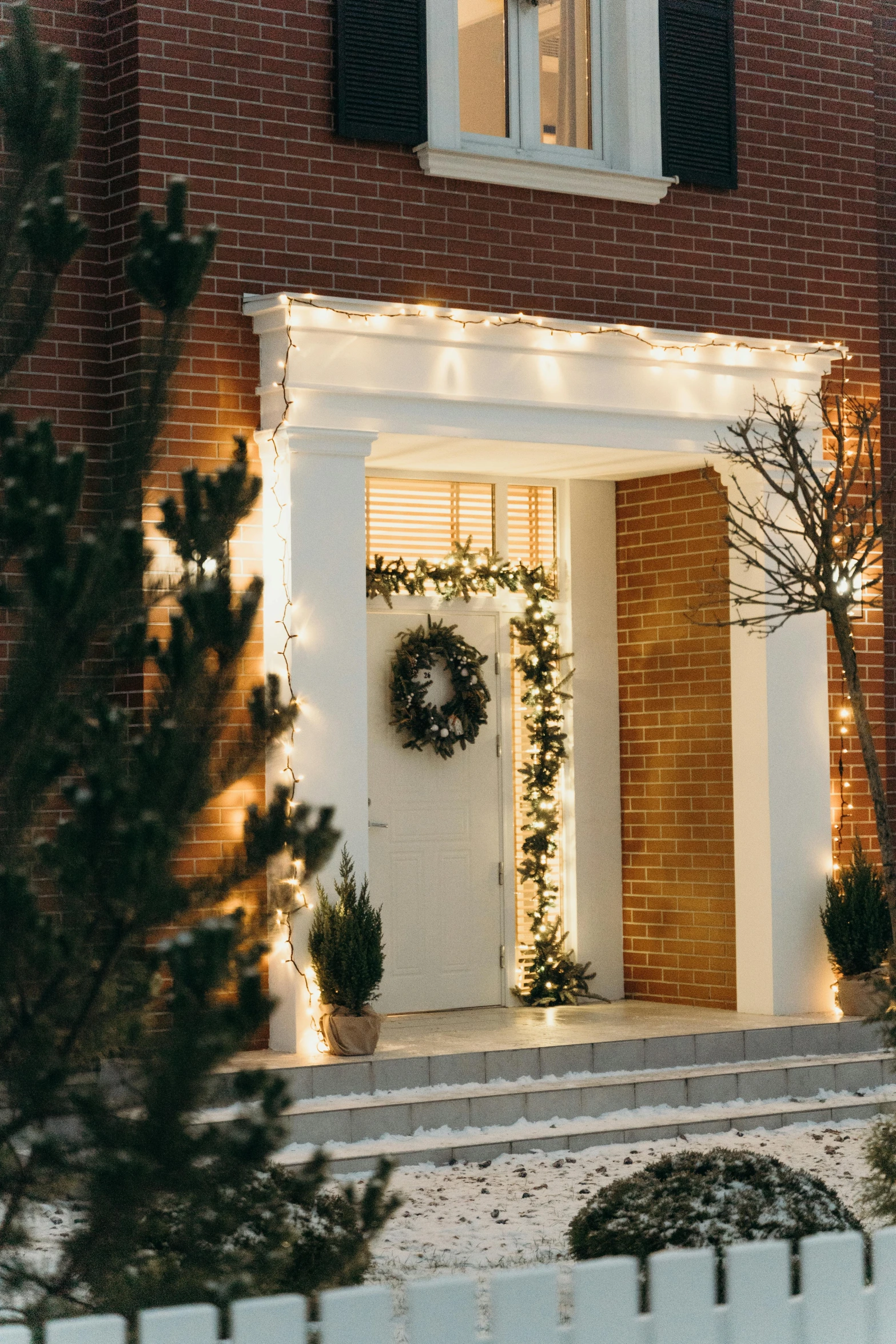 a house with christmas lights on the front of it, doorway, warm natural lighting, profile image, tonal colors outdoor