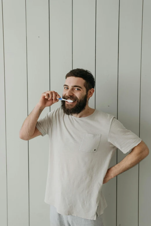 a man standing in front of a wall brushing his teeth, by Adam Dario Keel, happening, short beard, profile image, she has perfect white teeths, australian