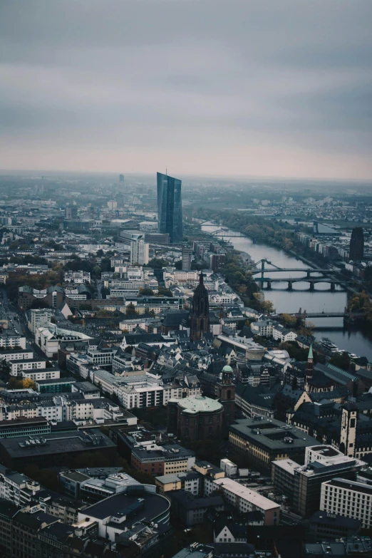 a view of a city from the top of a building, by Sebastian Spreng, pexels contest winner, happening, germany. wide shot, massive river, expansive detailed layered city, tall thin build