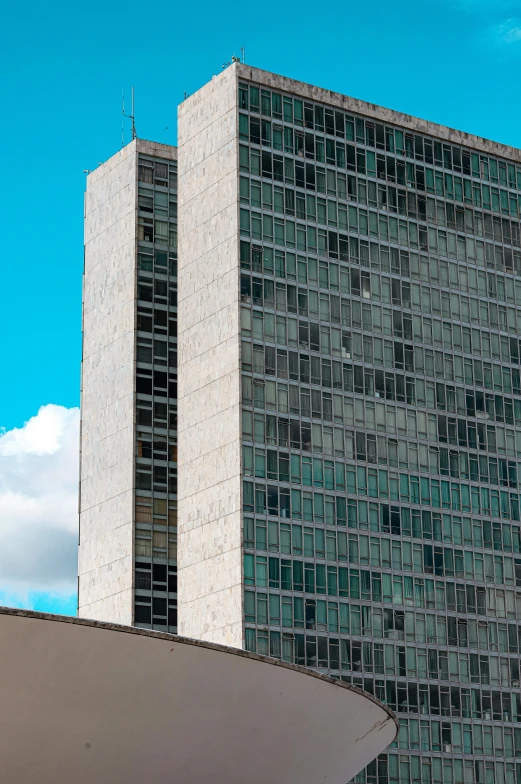 a couple of tall buildings sitting next to each other, brutalism, clear blue skies, government archive photograph, banner, ultra high resolution