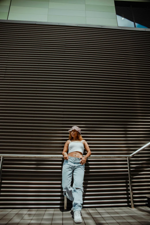 a woman standing in front of a set of stairs, pexels contest winner, baggy jeans, trending on vsco, wearing crop top, heavy lines