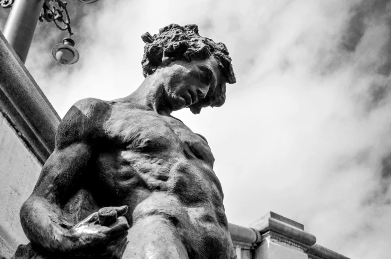 a black and white photo of a statue, a statue, inspired by Michelangelo Unterberger, pexels contest winner, mannerism, a photo of a disheveled man, hercules, street photo, sculpture made of gold