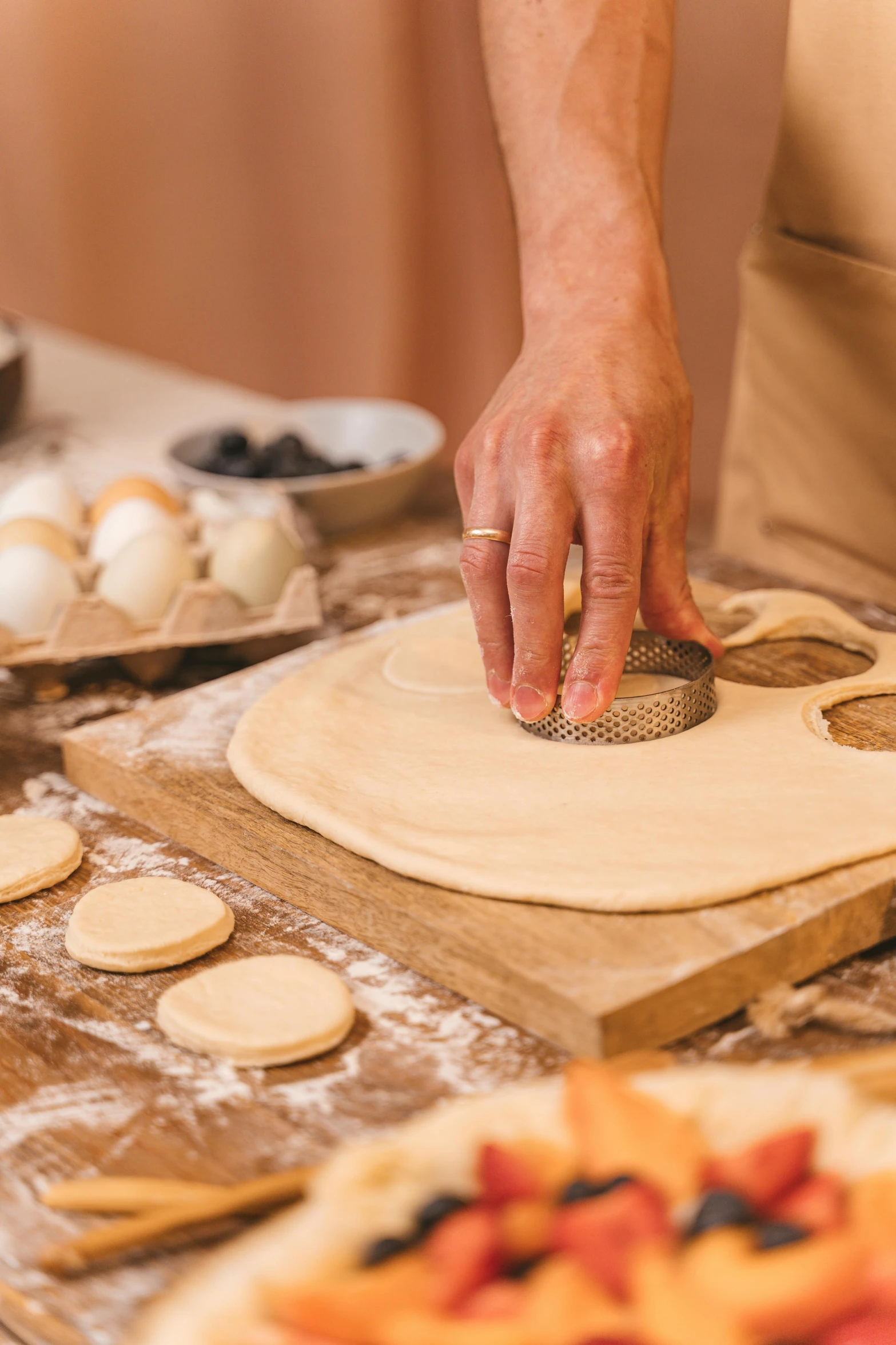 a close up of a person making food on a table, soft shapes, circles, bakery, entertaining