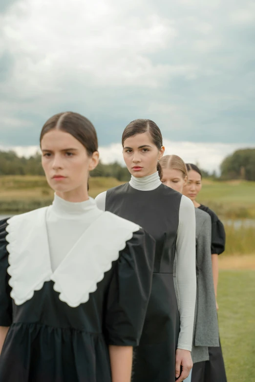 a group of women standing next to each other on a field, an album cover, inspired by Vanessa Beecroft, unsplash, renaissance, thick collar, russia, nun fashion model, profile pic