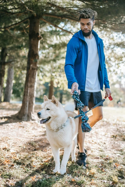 a man walking his dog in the woods, unsplash, renaissance, sport clothing, asian male, blue, full frame image