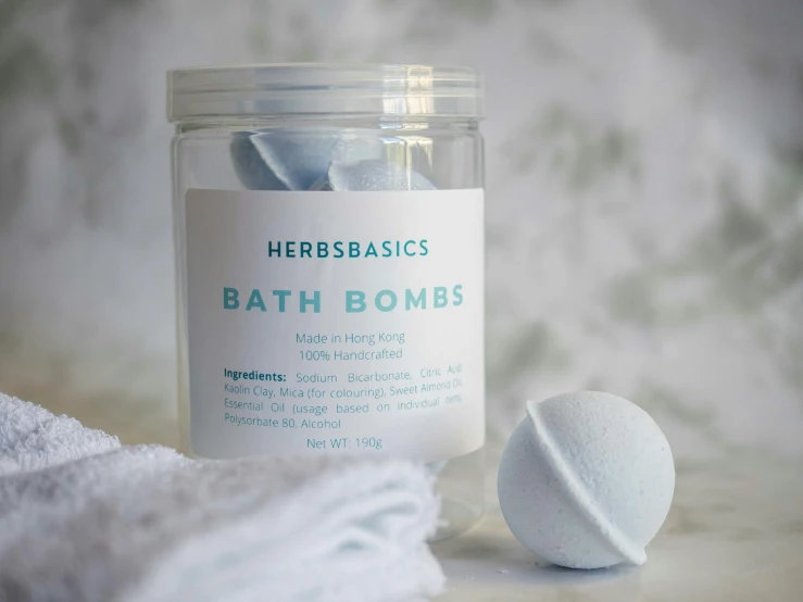 a jar of bath bombs next to a pile of towels, bauhaus, hero, metaballs, light blue robes, basic