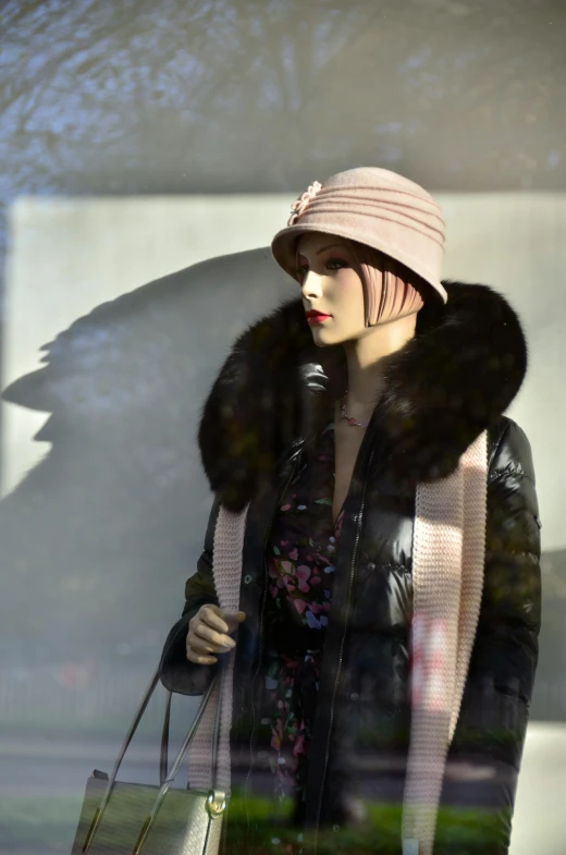 a woman that is standing in front of a window, an art deco sculpture, by Bernie D’Andrea, pixabay, fur hood, on a mannequin. high resolution, wearing a pink head band, photograph credit: ap