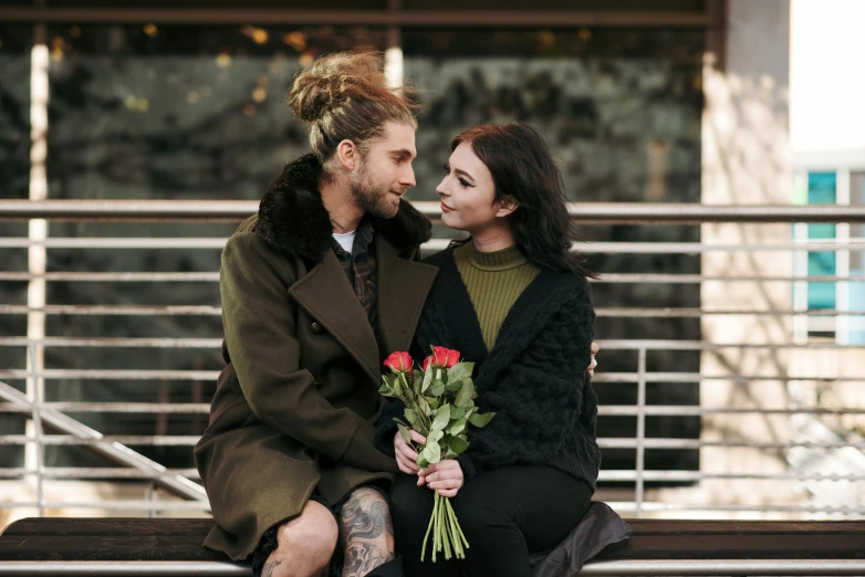 a man and woman sitting next to each other on a bench, pexels contest winner, holding a rose, woman with braided brown hair, caucasian, girls