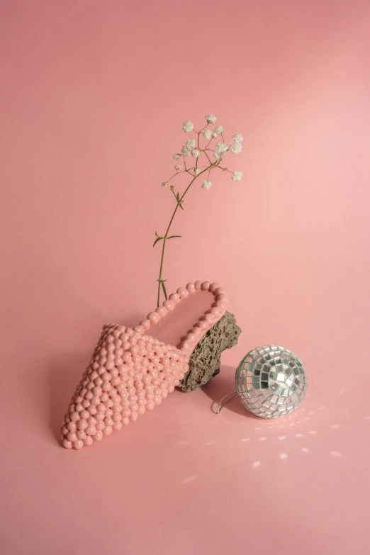 a pair of pink shoes next to a disco ball, inspired by Yayou Kusama, magic realism, crochet, sustainable materials, slippers, pinecone