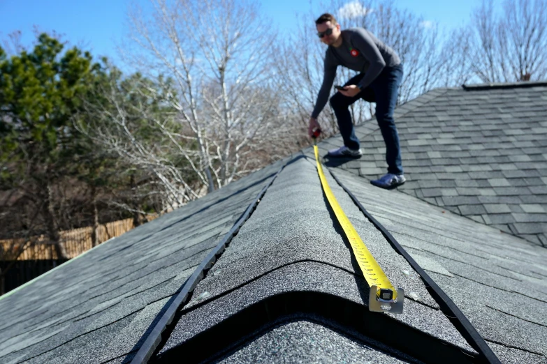 a man that is standing on top of a roof, measurements, easy edges, black roof, easy to use