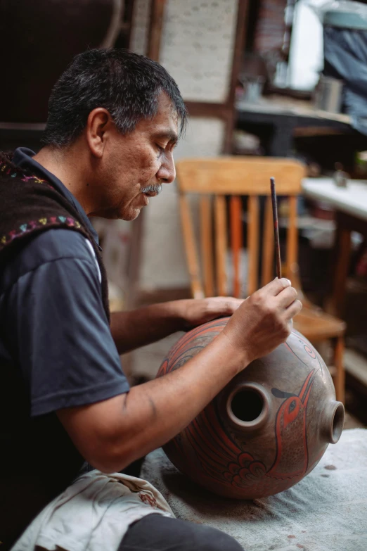 a man that is sitting down with a vase, pexels contest winner, process art, peruvian looking, carefully crafted, restoration, looking across the shoulder