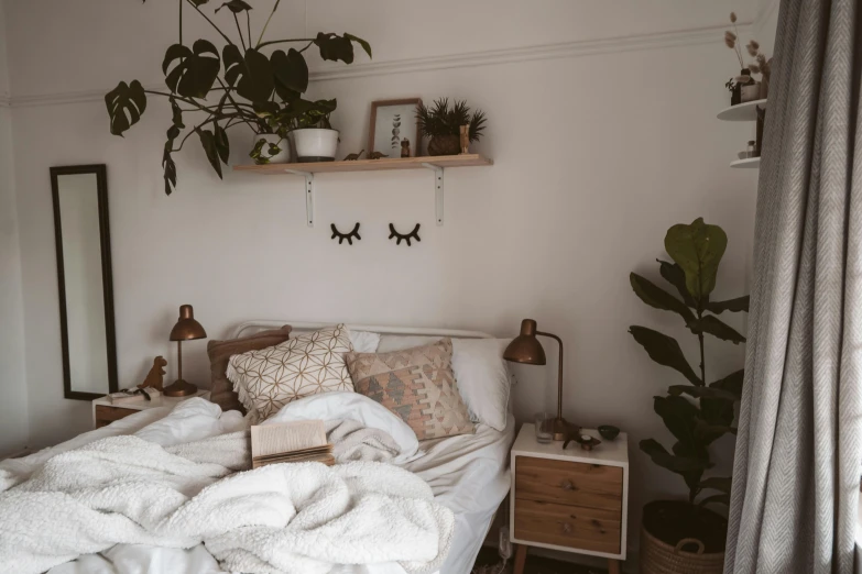 a bed sitting in a bedroom next to a window, inspired by Elsa Bleda, trending on pexels, lush plant growth, with a bunch of stuff, with a bunk bed, brown and white color scheme