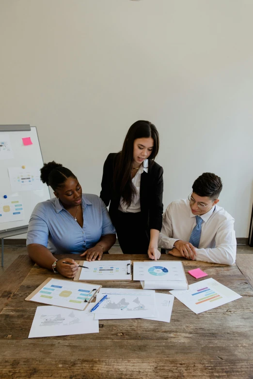 a group of people sitting around a wooden table, graphs, on a white table, thumbnail, beautiful photo