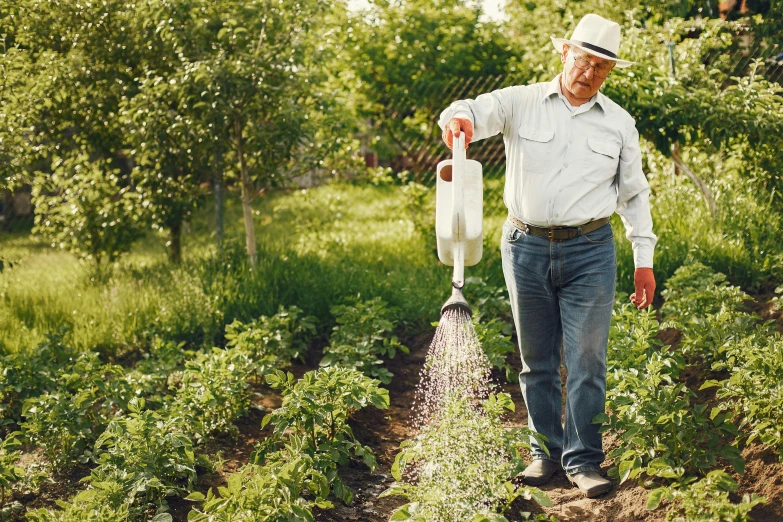 a man that is standing in the grass with a watering hose, cream of the crop, profile image, lush garden surroundings, thumbnail