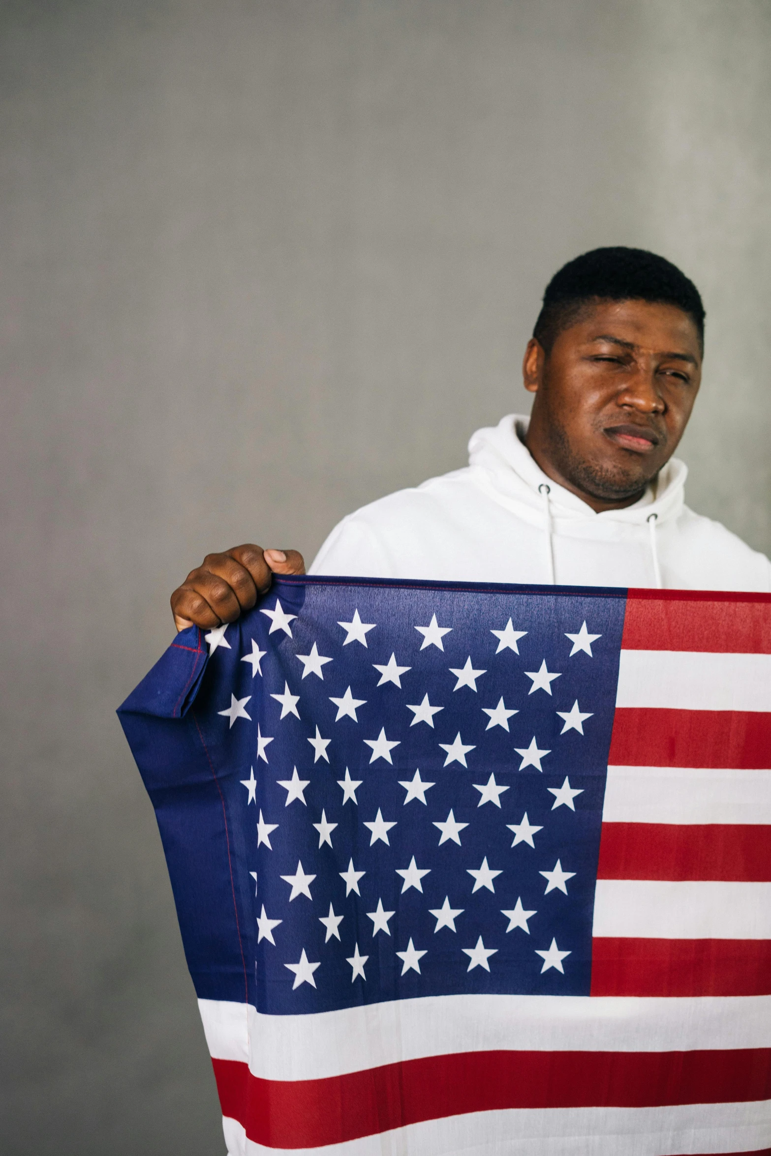 a man holding an american flag in his hands, an album cover, trending on unsplash, renaissance, handsome hip hop young black man, yung lean, disappointed, state of the union