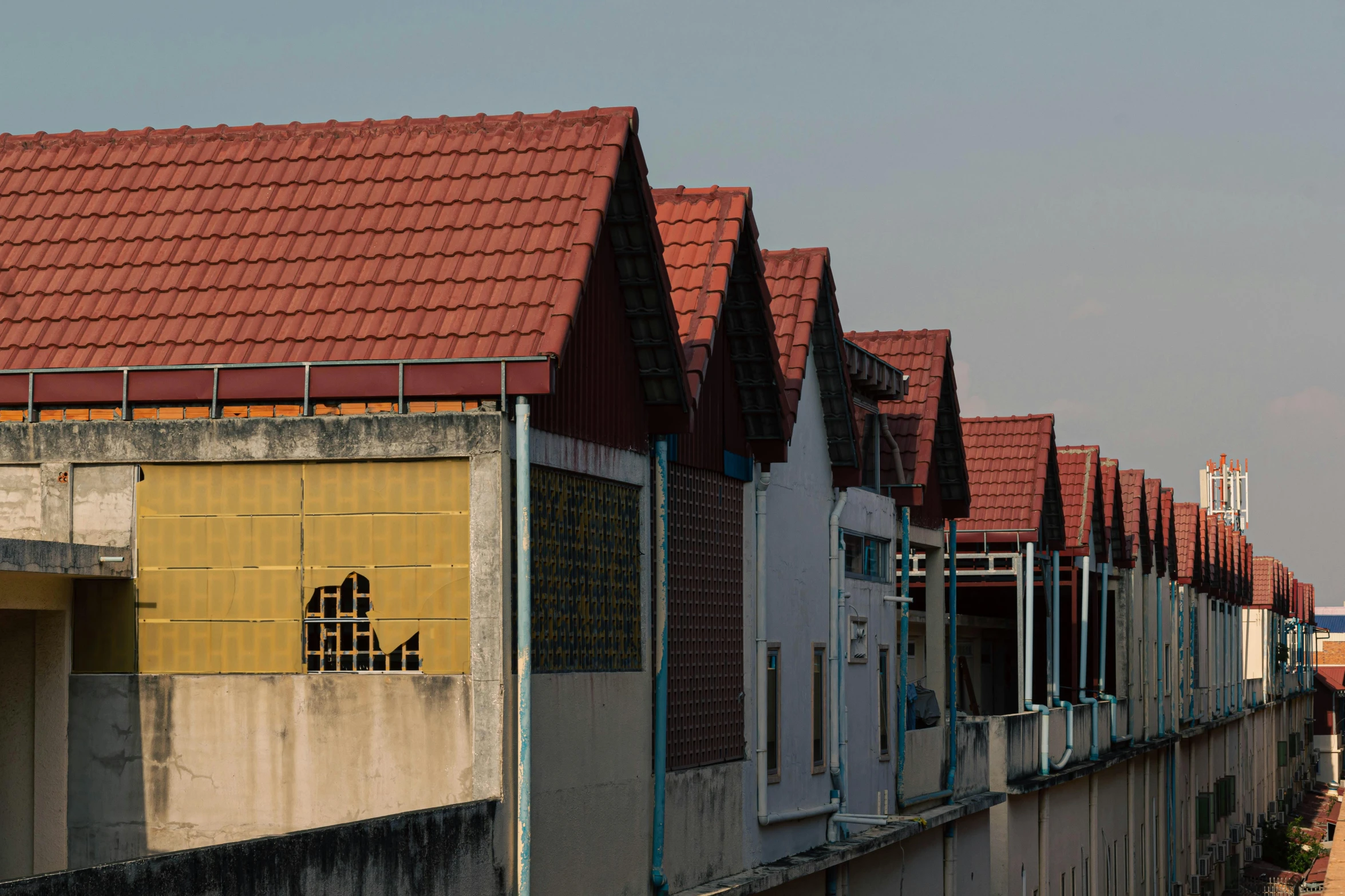 a couple of buildings that are next to each other, inspired by Zhang Kechun, unsplash, photorealism, red roofs, profile image, in a row, seen from the back