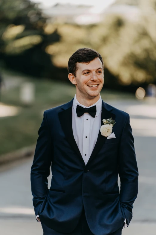 a man in a tuxedo standing on a street, inspired by Robert Scott Lauder, featured on reddit, renaissance, smiling male, wedding, zoomed out, sydney hanson