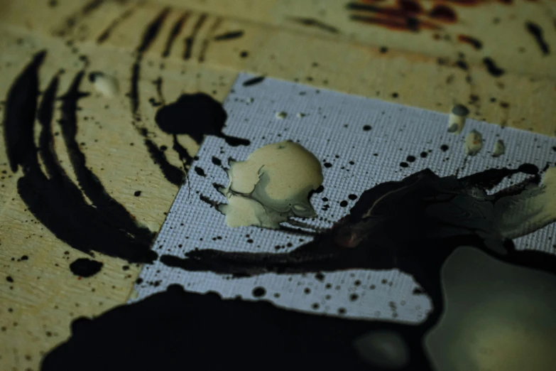 a computer mouse sitting on top of a piece of paper, a microscopic photo, inspired by Antoni Tàpies, unsplash, smothered in melted chocolate, film still from horror movie, strong eggshell texture, stop motion animation