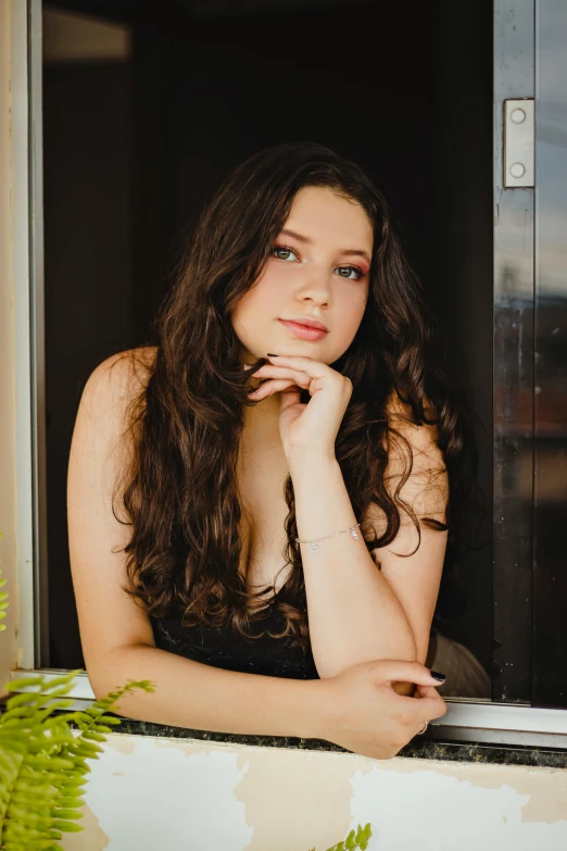 a woman sitting on a window sill next to a potted plant, an album cover, pexels contest winner, renaissance, beautiful kat dennings, headshot profile picture, anna nikonova aka newmilky, long curly black hair