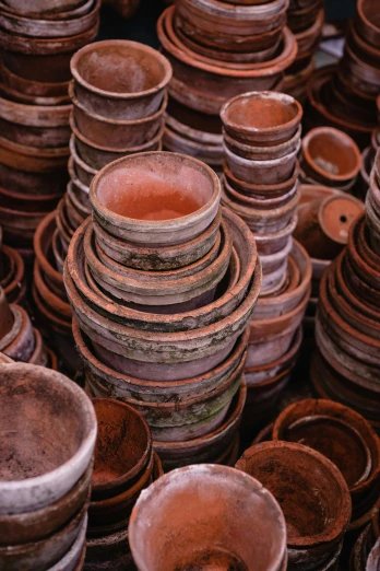 a pile of clay pots sitting on top of each other, unsplash, cloisonnism, brown holes, as photograph, ((rust)), dish