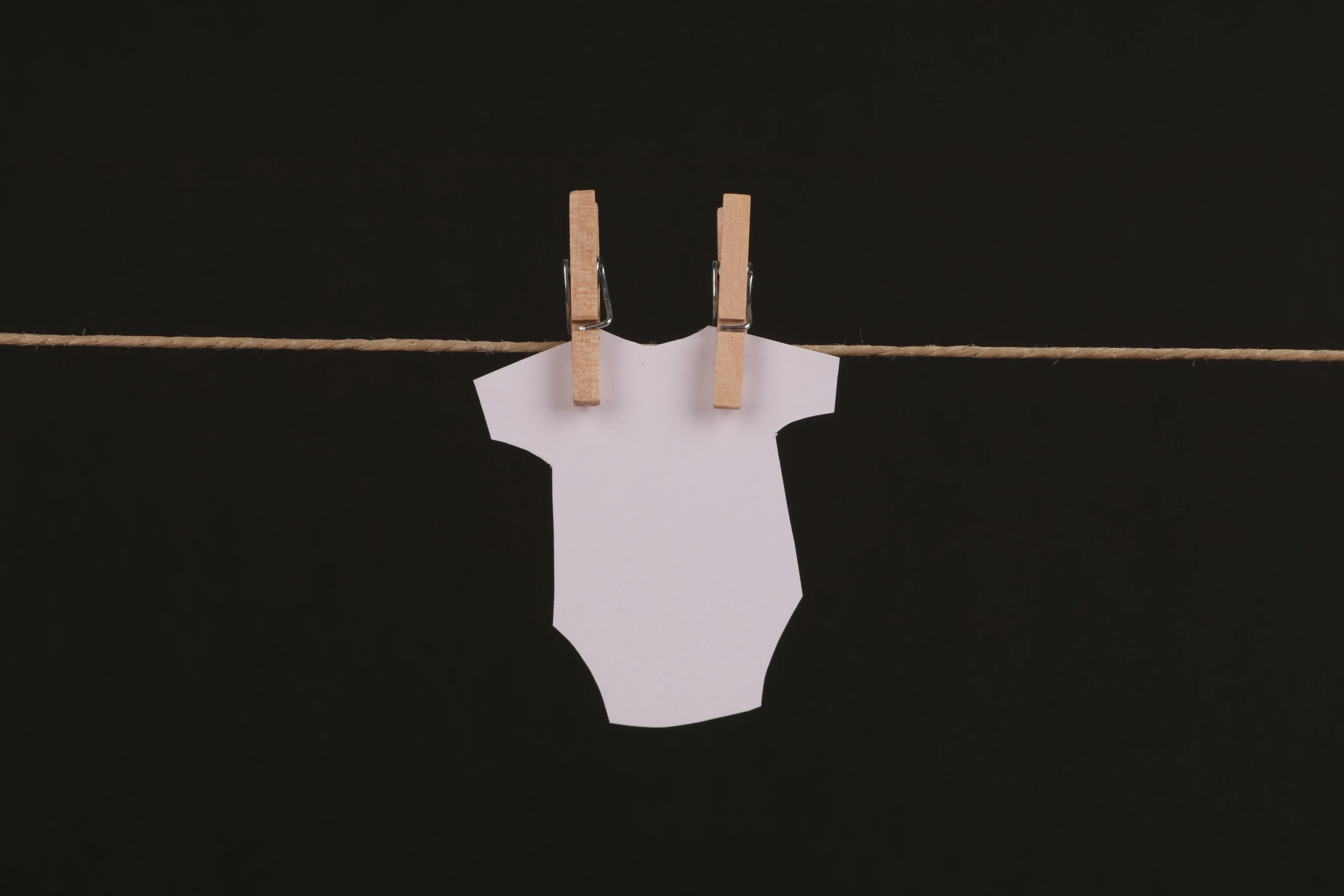 clothes hanging on a clothes line with clothes pegs, an album cover, unsplash, diaper-shaped, bodysuit, paul barson, white