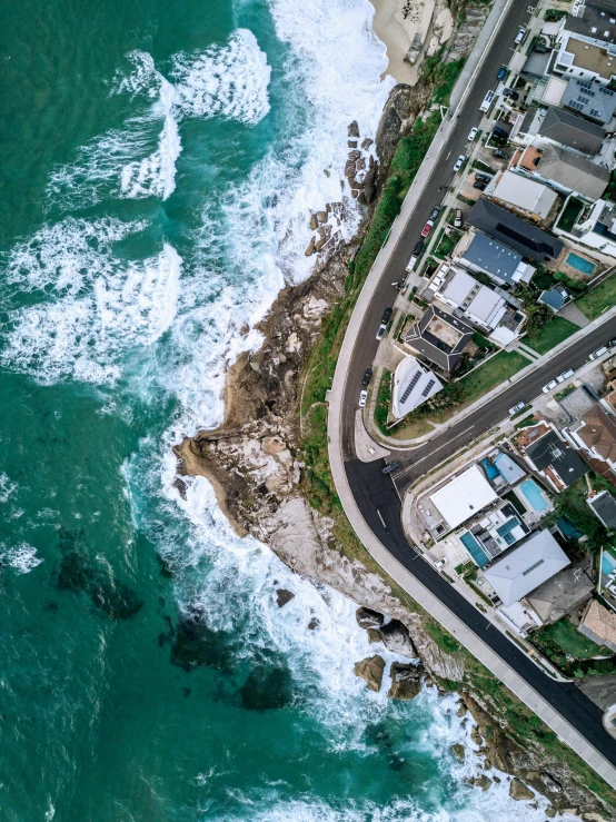 an aerial view of a city next to the ocean, by Daniel Lieske, pexels contest winner, houses and roads, profile pic, top view of convertible, ocean swells