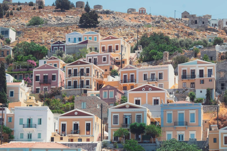 a bunch of houses sitting on top of a hill, a colorized photo, pexels contest winner, hyperrealism, greek architecture, ochre, light pink tonalities, square