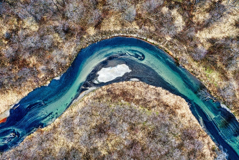 an aerial view of a body of water, by Muggur, pexels contest winner, land art, with a river running through it, blue-green fish skin, spring winter nature melted snow, thumbnail