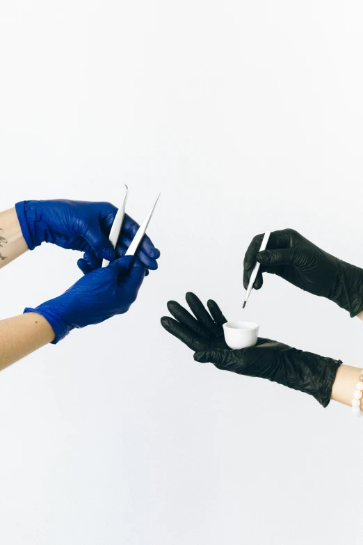 a person cutting another person's finger with scissors, by Adam Marczyński, plasticien, blue gloves, black, implants, contain