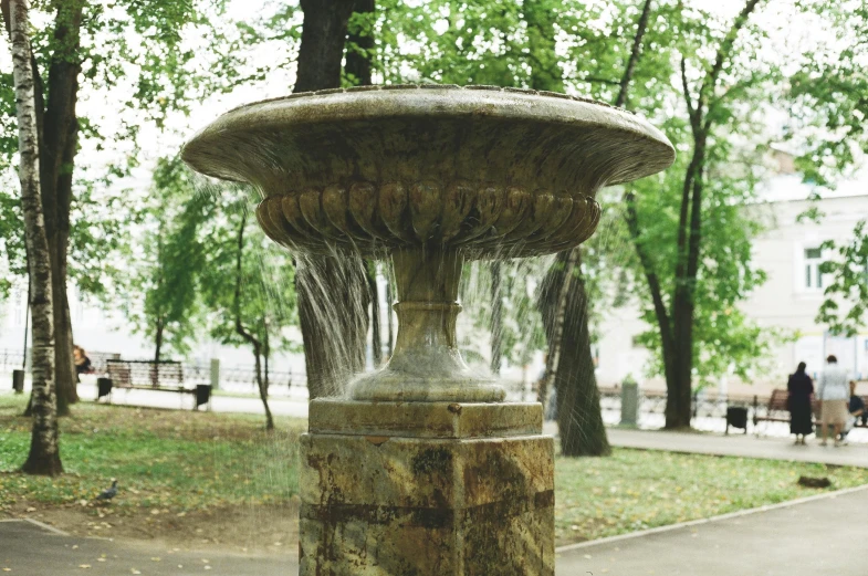 a water fountain sitting in the middle of a park, street of moscow, fan favorite, shot onfilm, damp