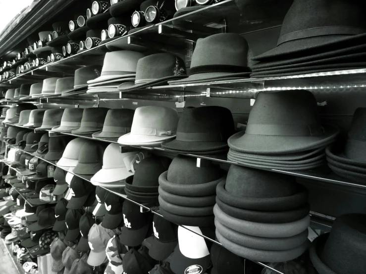 a black and white photo of a wall of hats, a black and white photo, manly, clones, dim, collection product