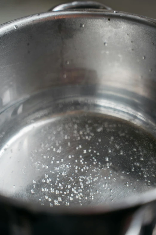 a pot of boiling water on a stove, by Ryan Pancoast, jelly - like texture, shiny silver, high quality image, round-cropped