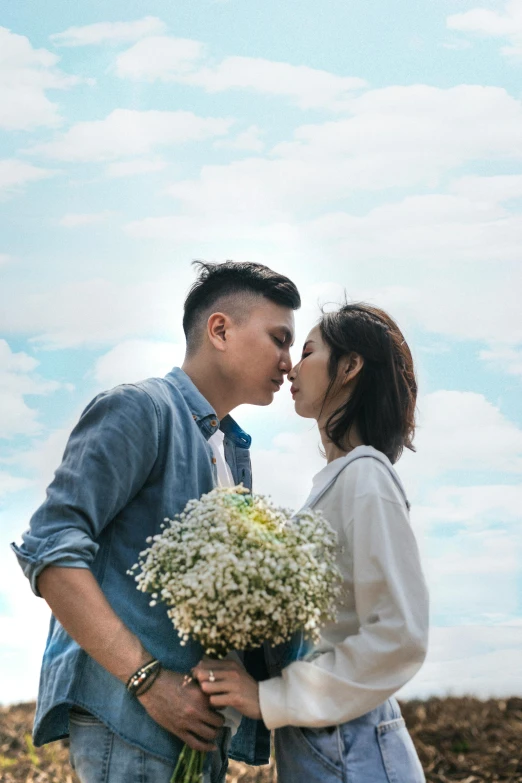 a man and woman standing next to each other in a field, pexels contest winner, asian male, bouquet, licking, ( ( theatrical ) )