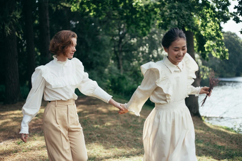 a couple of women standing next to each other holding hands, pexels contest winner, renaissance, wearing a white blouse, walking at the park, vintage clothing, happy friend