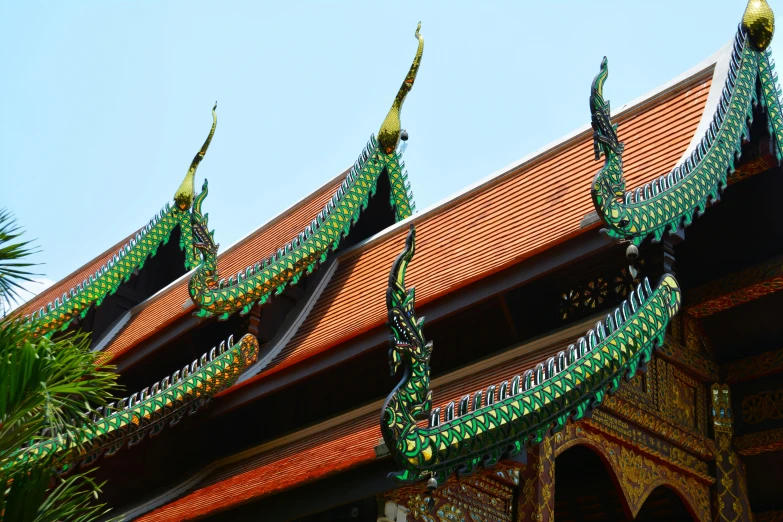 a row of dragon heads on the roof of a building, by Meredith Dillman, pexels contest winner, cloisonnism, thai temple, green, intricate geometry, “ painting