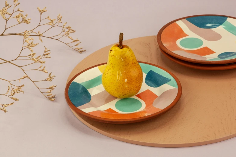 a close up of a plate with a pear on it, inspired by Sarah Morris, trending on dribble, terracotta, orange and cyan paint decals, wooden platforms, petite pear slim figure